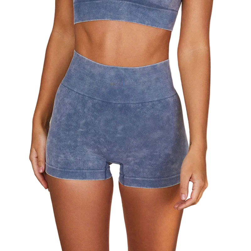 Blue ribbed athletic shorts worn by a person on a beige background