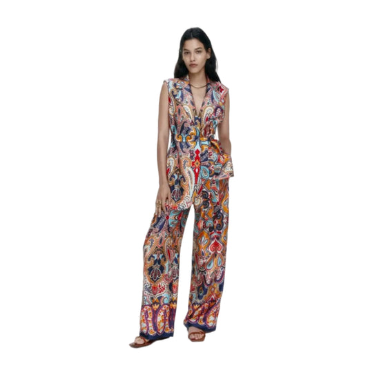 Woman wearing a colorful paisley outfit on a white background