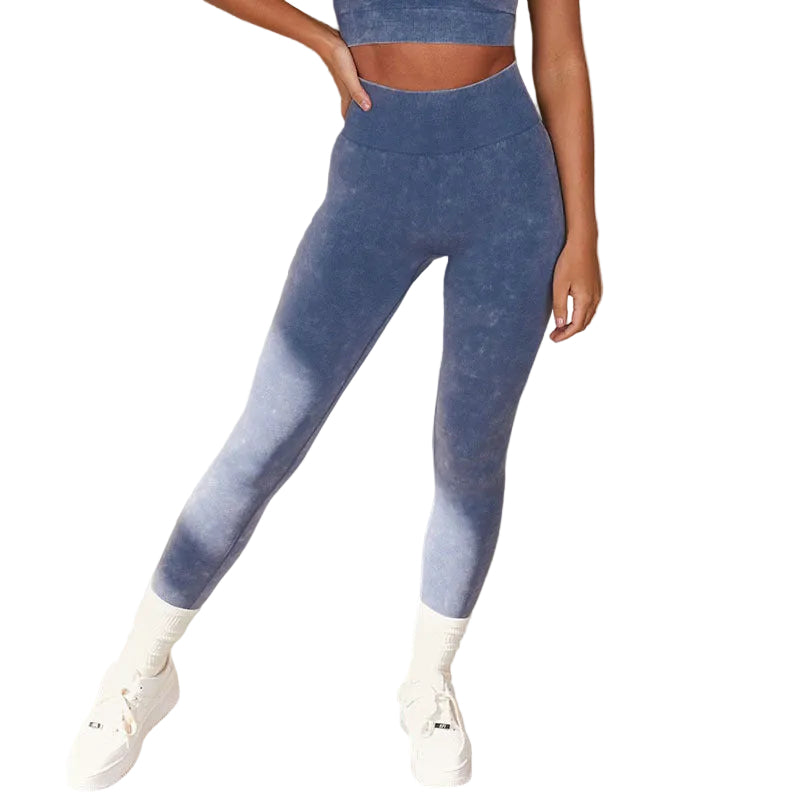 Person wearing blue gradient leggings and white sneakers against a neutral background