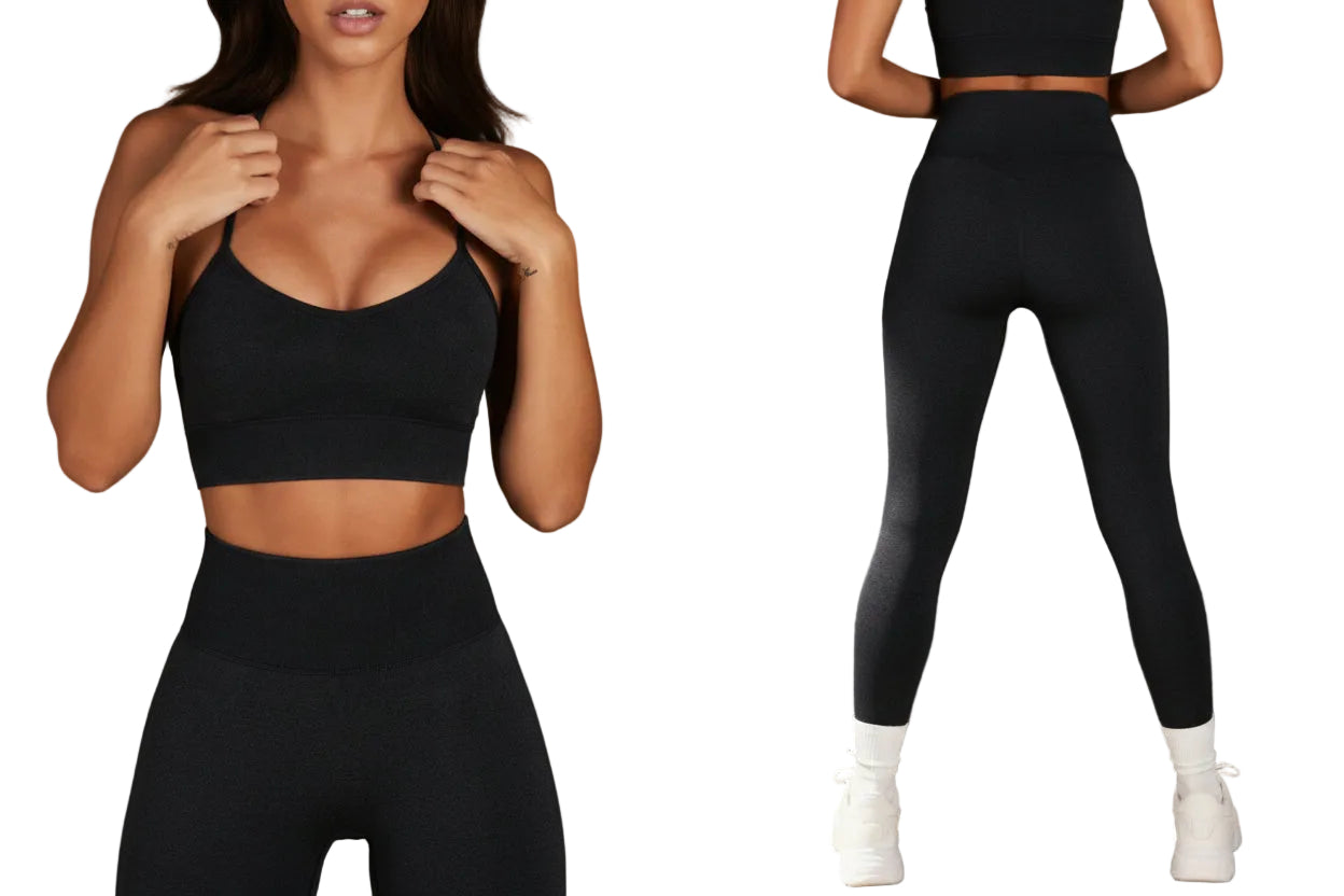 Woman wearing black athletic wear against a concrete wall.